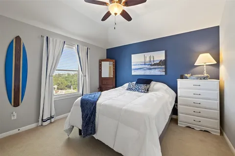 a spacious bedroom with a bed and a flat screen tv