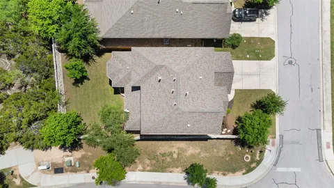 an aerial view of a house with a yard