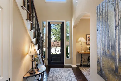 a view of an entryway with wooden floor and a livingroom