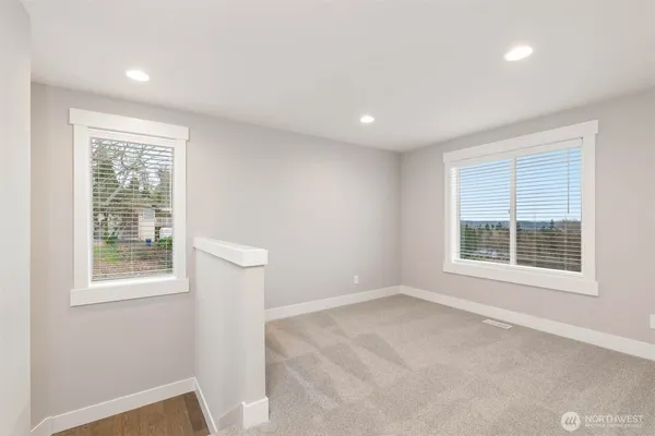 an empty room with windows and closet