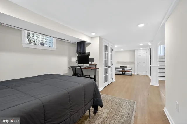 a bed room with a bed furniture and a flat screen tv