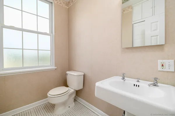 a white toilet sitting next to a bathroom sink