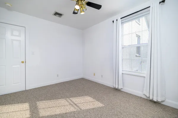 an empty room with a empty space and chandelier fan