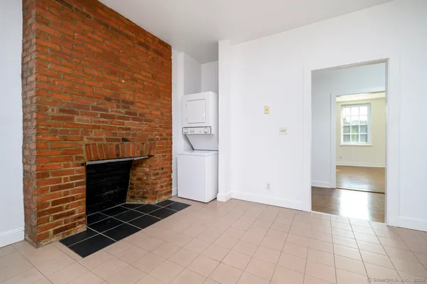 a view of an empty room and fire place