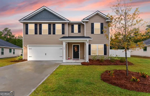 a front view of a house with a yard