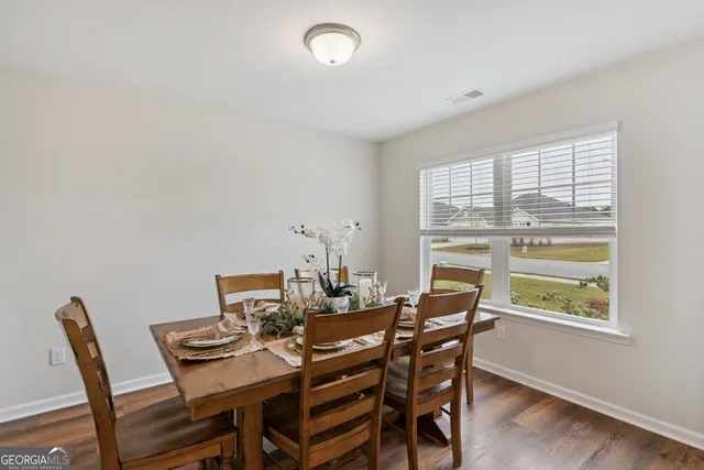 a living room with furniture a flat screen tv and a window