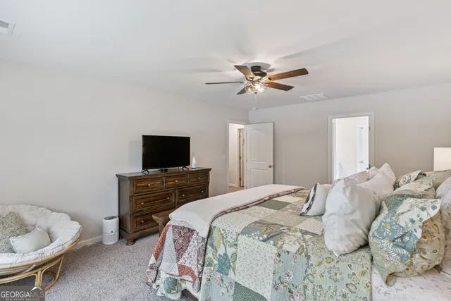 a bedroom with a bed and a desk