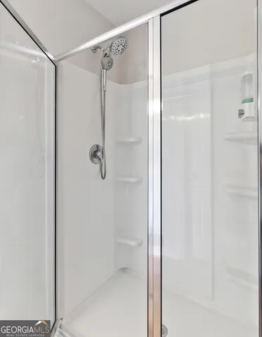 a view of walk in closet with clothes