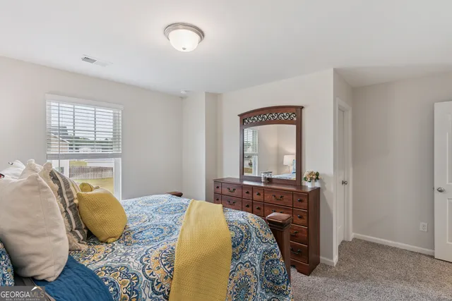 a bedroom with a bed and a television