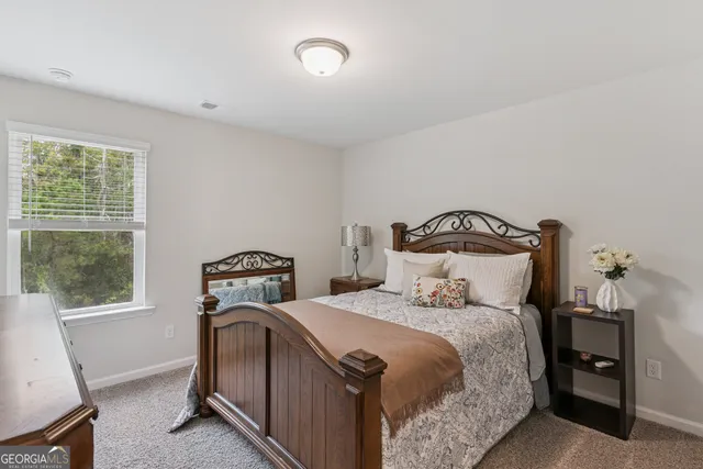 a bedroom with a bed and a potted plant
