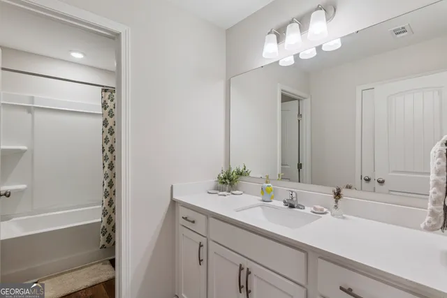 an aerial view of residential houses with yard