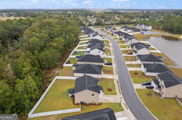 a view of a house with a yard and sitting area