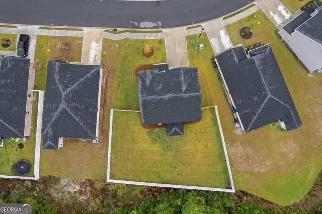 a front view of a house with yard and green space