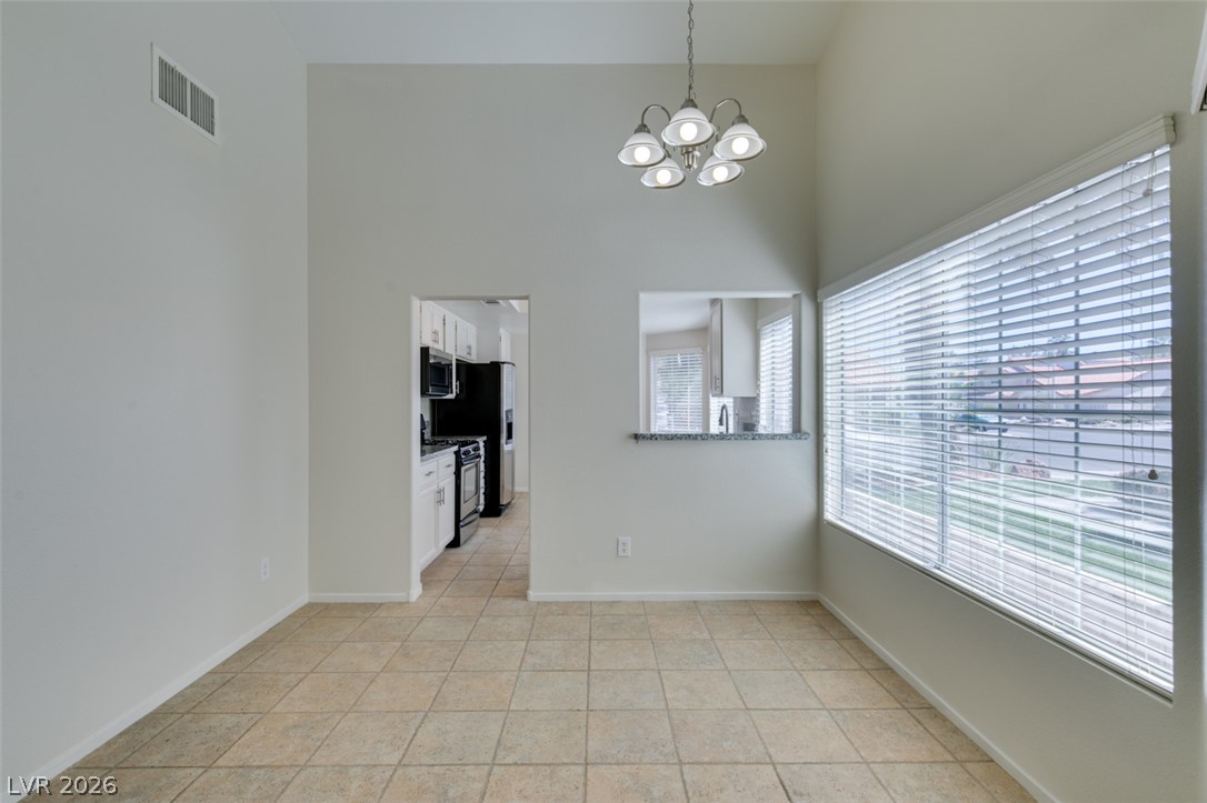 307 Cavalla Street Henderson, NV 89074 - Photo 17 of 44 A well-lit interior features a pass-through to the kitchen, perfect for effortless entertaining.