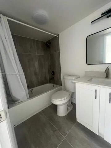 a bathroom with a toilet sink and bathtub