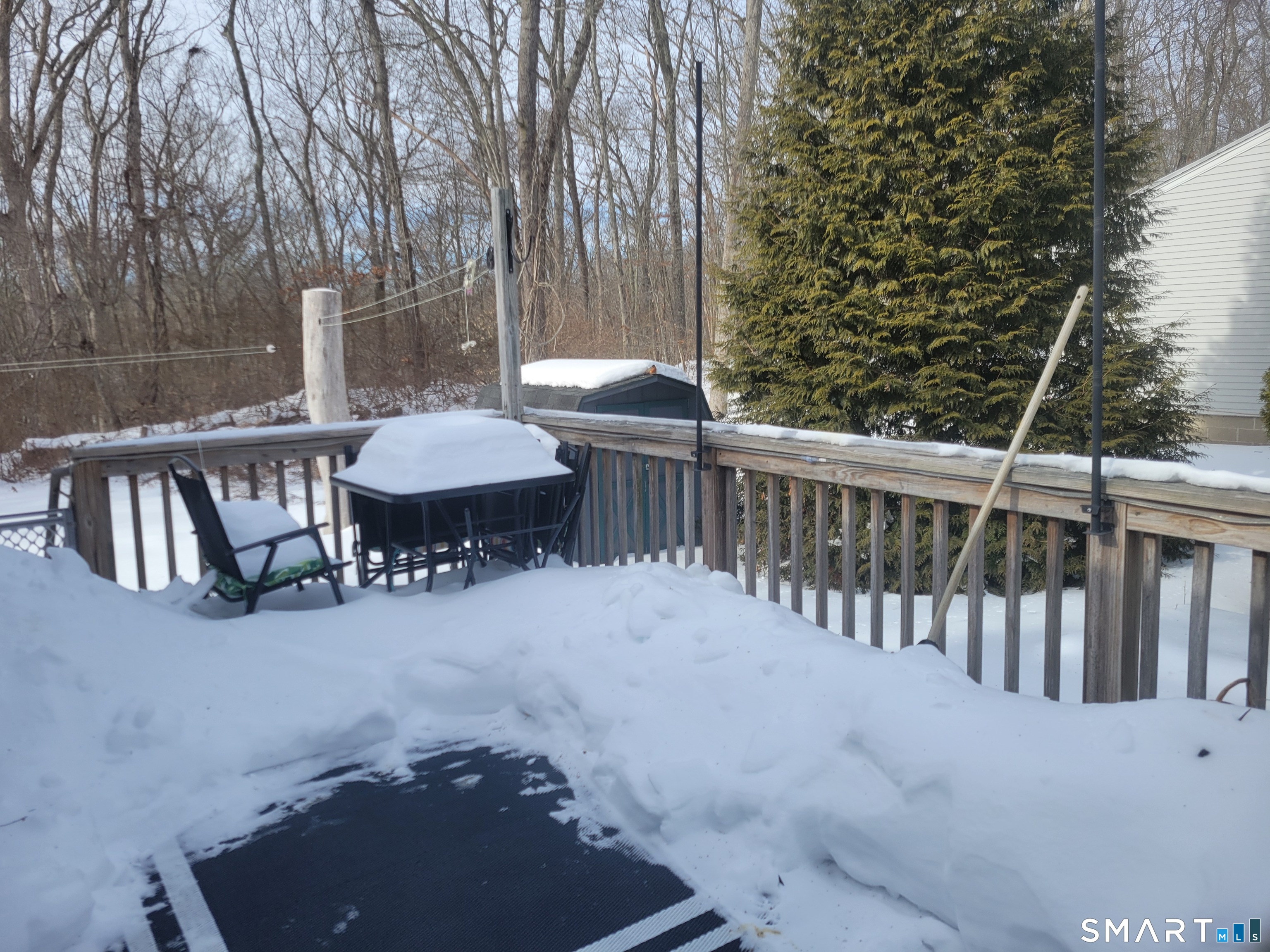 944 Long Cove Road Ledyard, CT 06335 - Photo 12 of 12 a view of a patio with table and chairs with wooden floor and fence