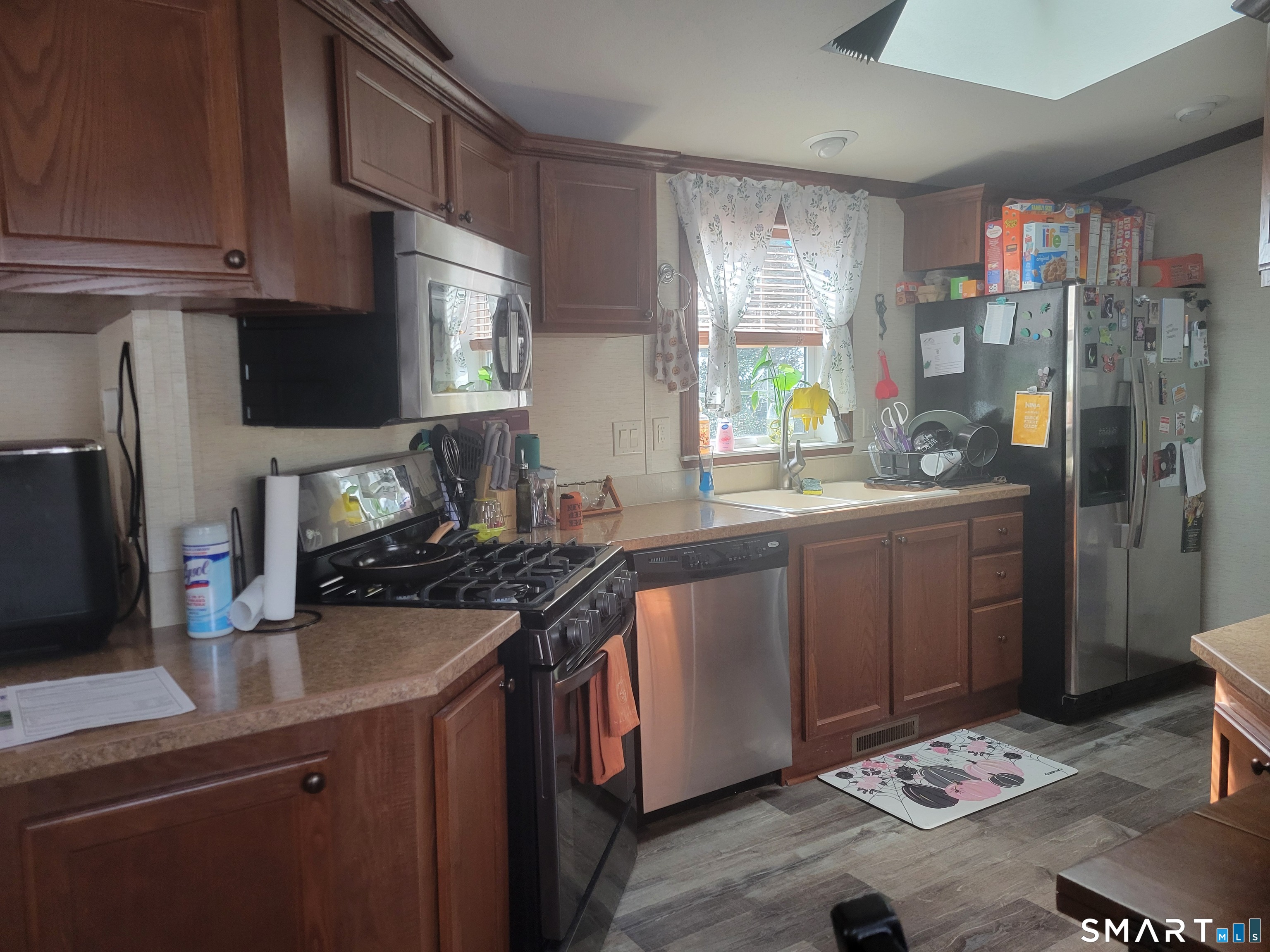 944 Long Cove Road Ledyard, CT 06335 - Photo 3 of 12 a kitchen with stainless steel appliances a sink stove and refrigerator