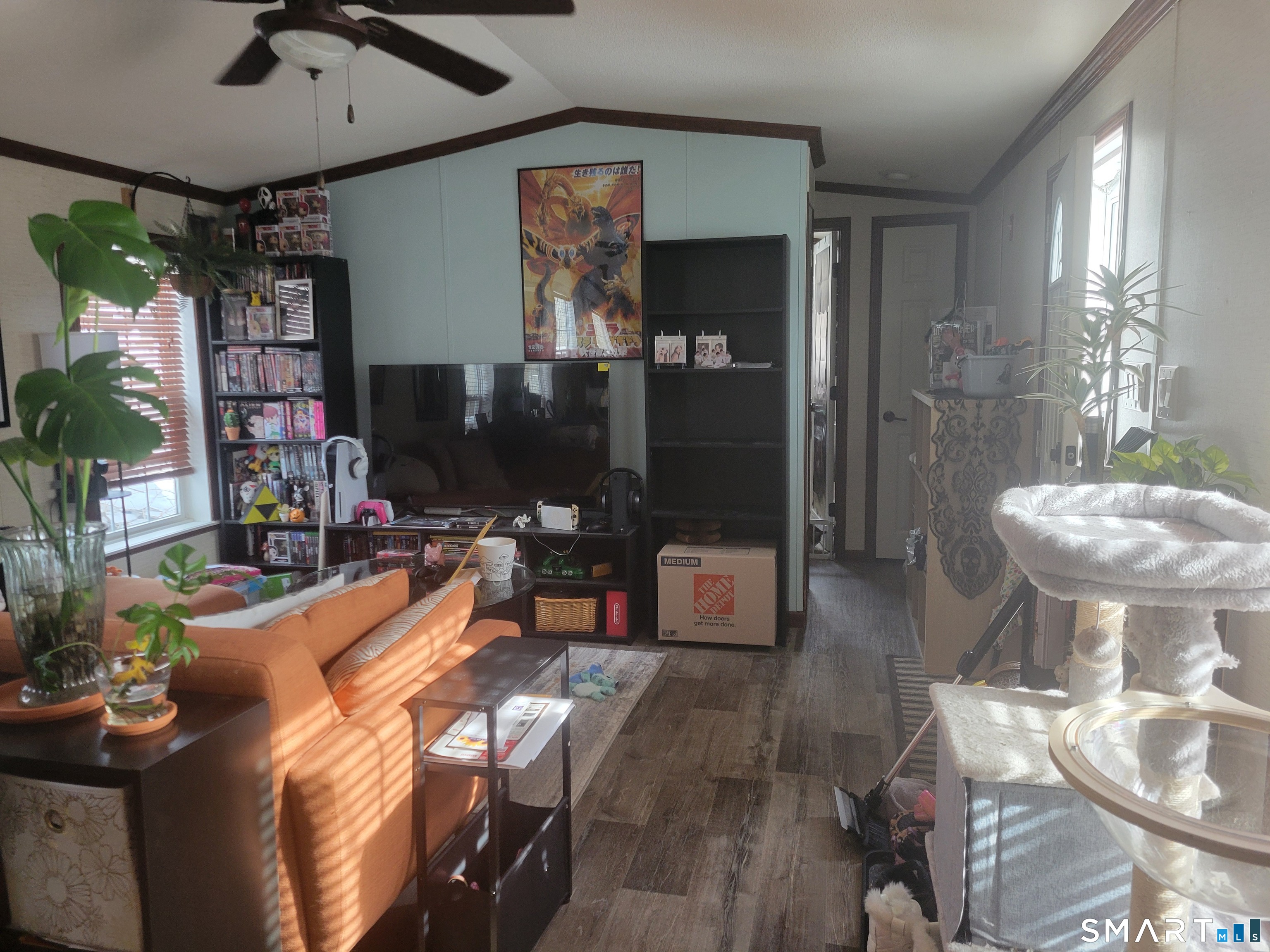 944 Long Cove Road Ledyard, CT 06335 - Photo 4 of 12 a living room with furniture a flat screen tv and a floor to ceiling window