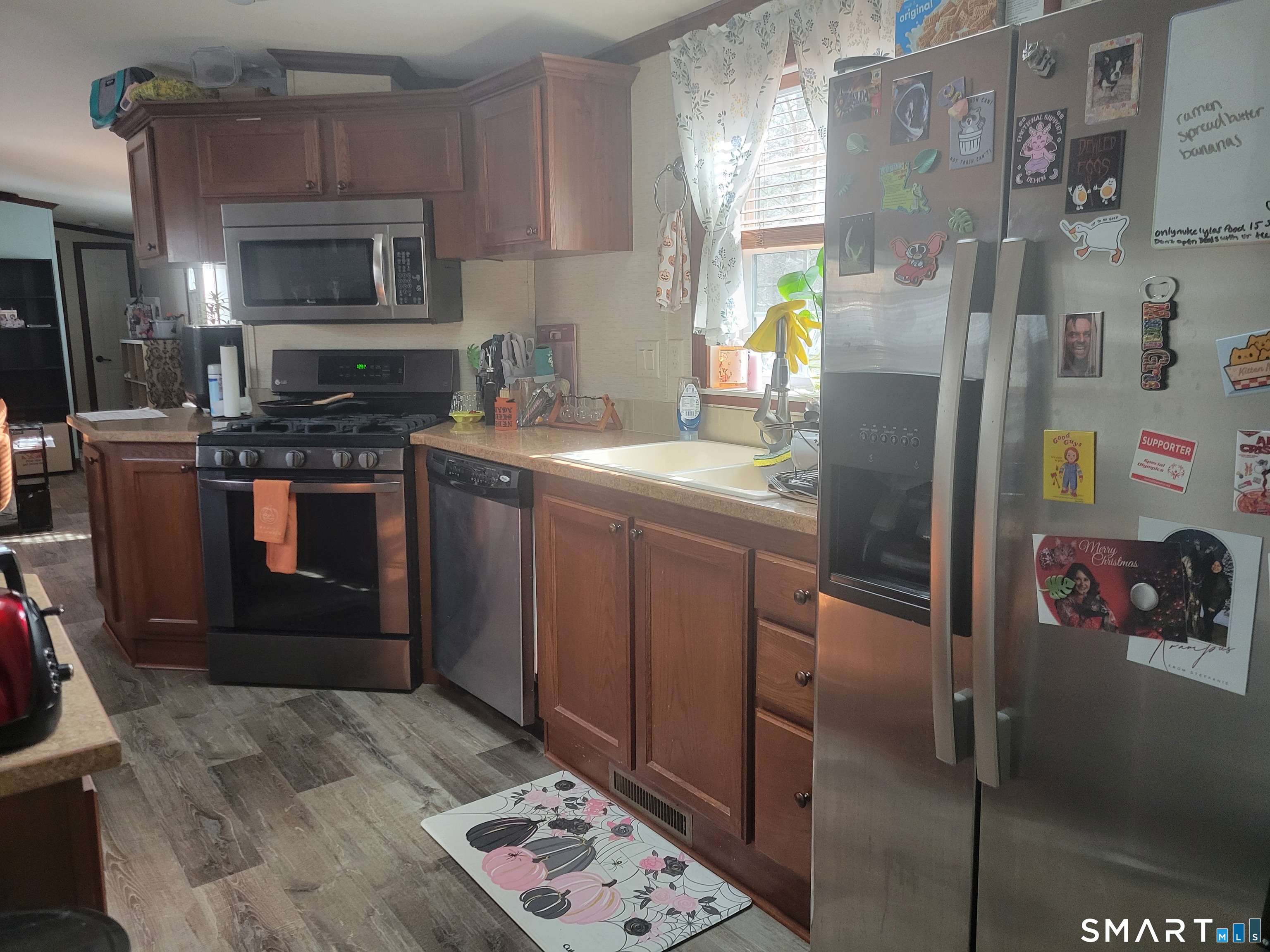 944 Long Cove Road Ledyard, CT 06335 - Photo 5 of 12 a kitchen with stainless steel appliances granite countertop a refrigerator a stove a sink and a microwave