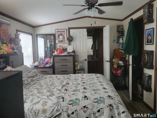 a bed room with a bed mirror and a window