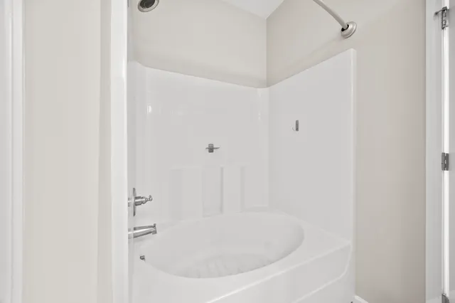 a white bath tub sitting in a bathroom