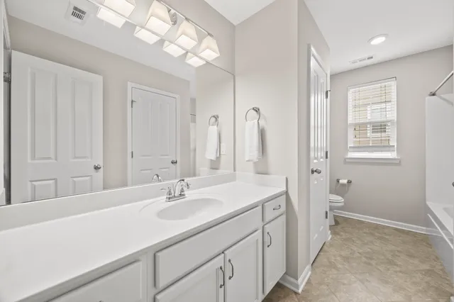 a bathroom with a sink a vanity and a mirror
