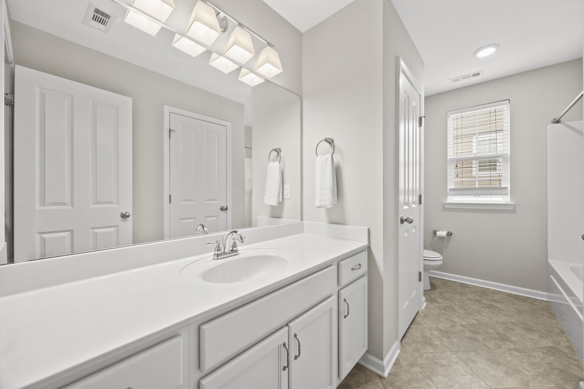 501 Shirebrook Circle Spring Hill, TN 37174 - Photo 20 of 26 a bathroom with a sink a vanity and a mirror