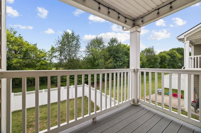 a view of a balcony with wooden floor