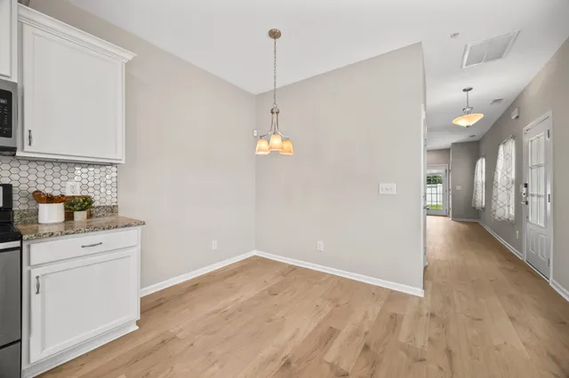 a view of a kitchen with a sink cabinets and wooden floor