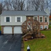a front view of a house with a garden and yard