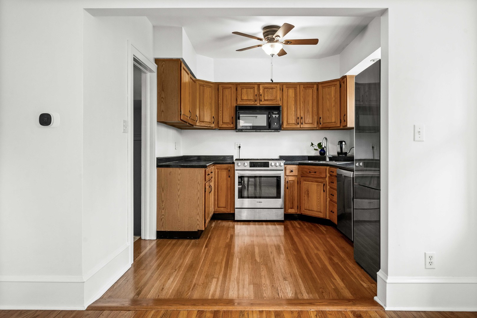 1302 Hillcrest Street Normal, IL 61761 - Photo 14 of 48 a kitchen with stainless steel appliances a sink a stove a refrigerator cabinets and a window