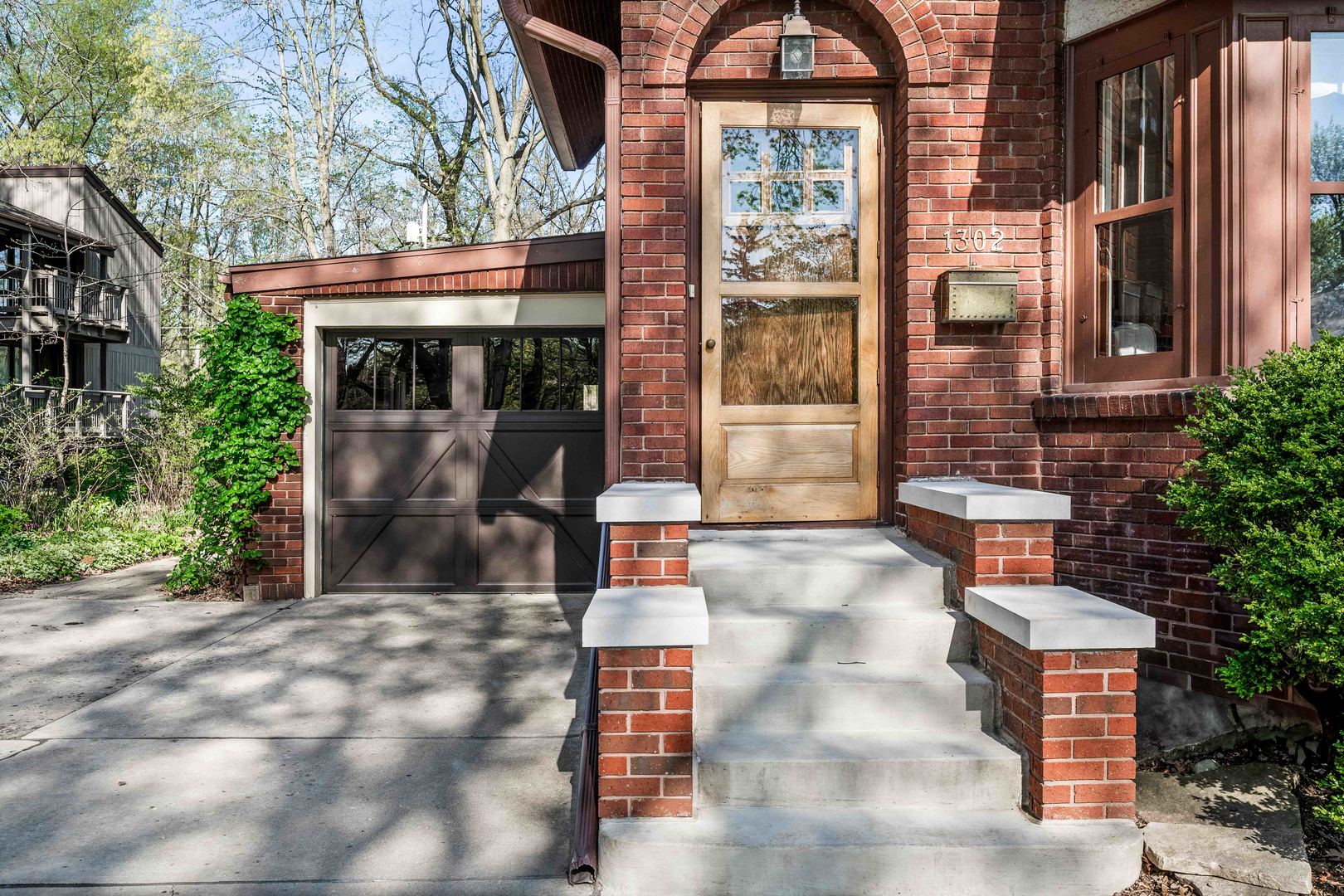 1302 Hillcrest Street Normal, IL 61761 - Photo 3 of 48 a front view of a building with a garden