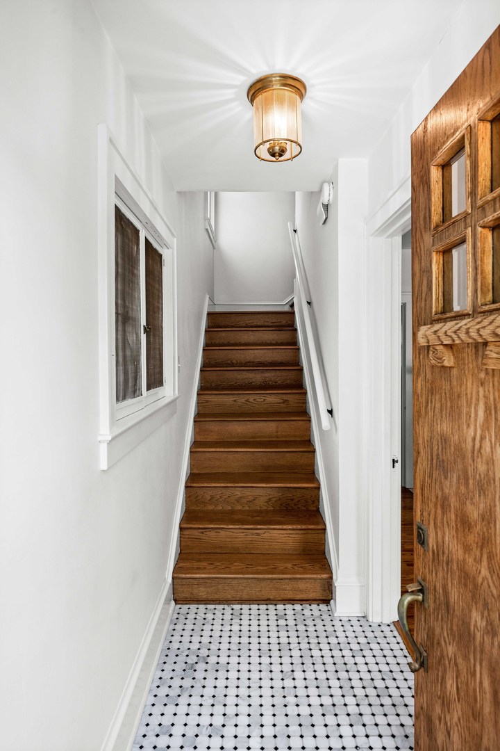 1302 Hillcrest Street Normal, IL 61761 - Photo 4 of 48 a view of a hallway to a house with wooden floor and windows