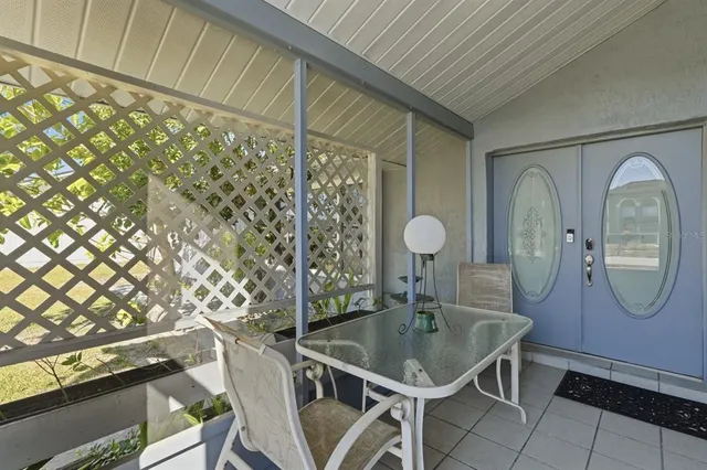 a view of a dining room with furniture and a chandelier