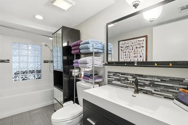 a bathroom with a sink toilet tub and shower