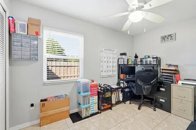 a view of a workspace with furniture and a window