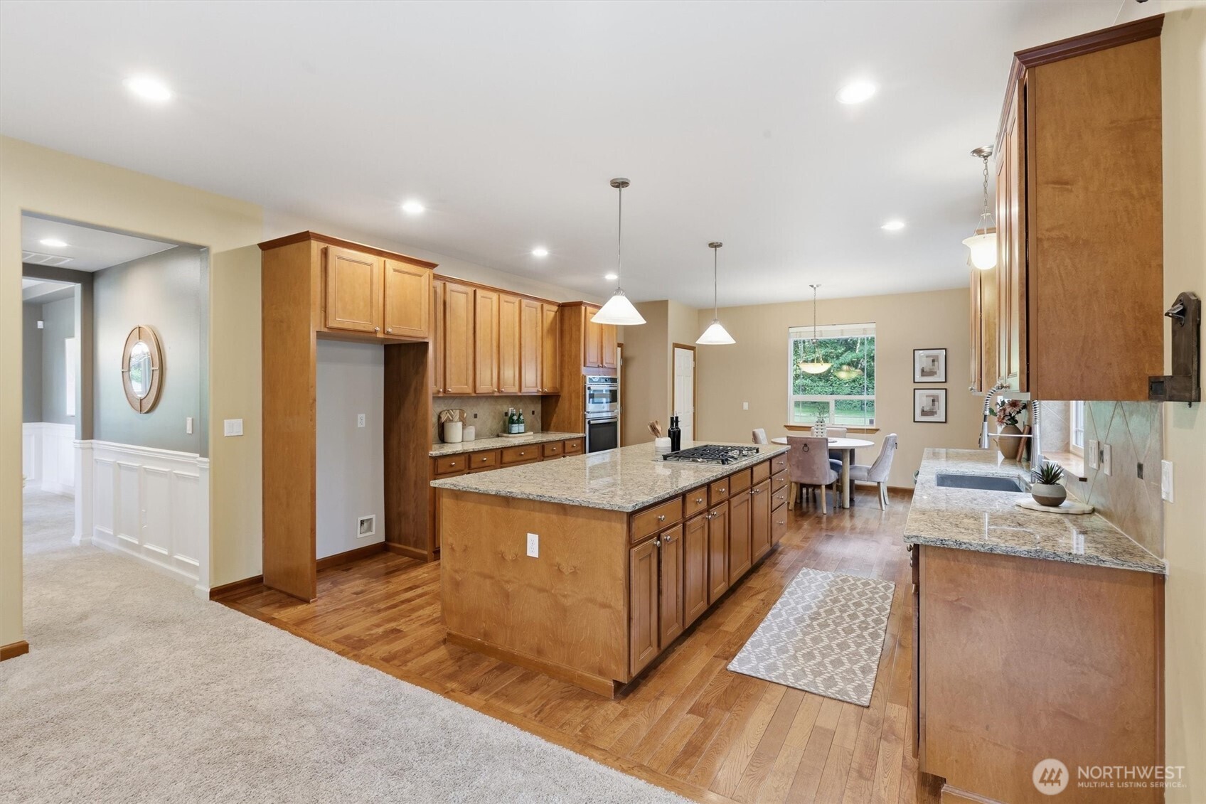4202 Silvana Terrace Road Stanwood, WA 98292 - Photo 19 of 40 a kitchen with stainless steel appliances granite countertop a stove top oven a refrigerator a sink and a cabinets