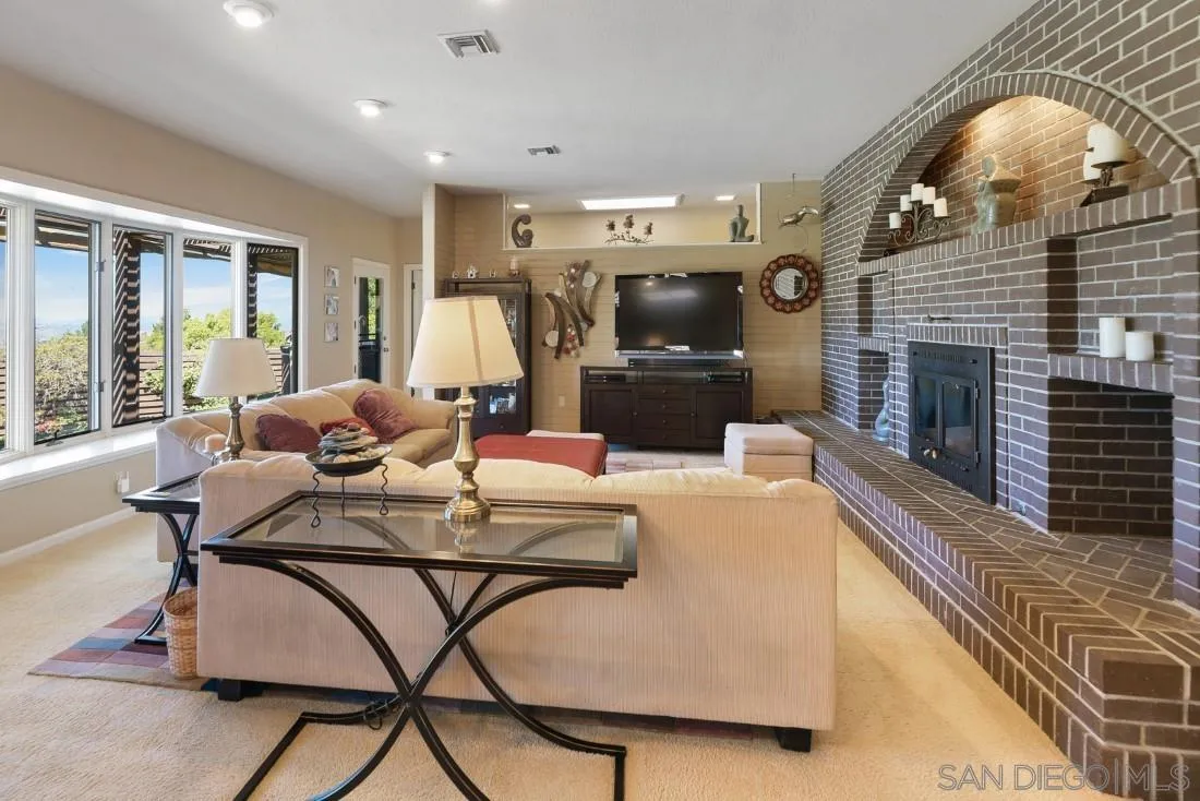 15938 Overview Road Poway, CA 92064 - Photo 26 of 72 a living room with fireplace furniture and a flat screen tv