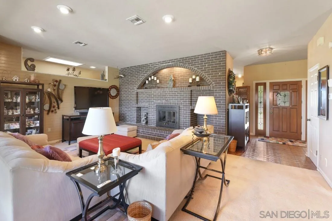 15938 Overview Road Poway, CA 92064 - Photo 27 of 72 a living room with furniture and a fireplace