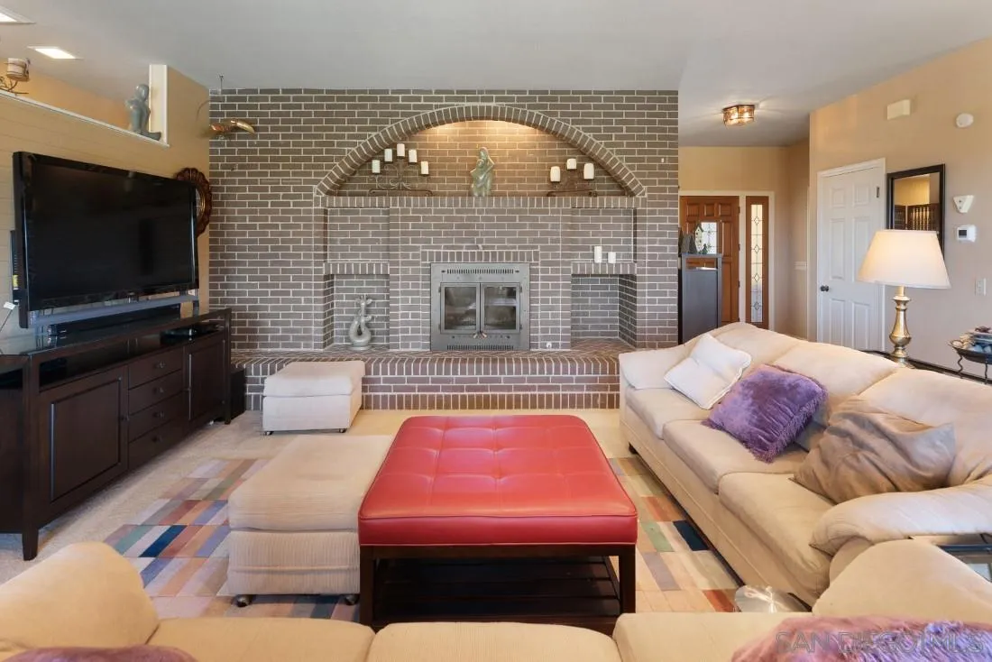 15938 Overview Road Poway, CA 92064 - Photo 28 of 72 a living room with a couch and a flat screen tv