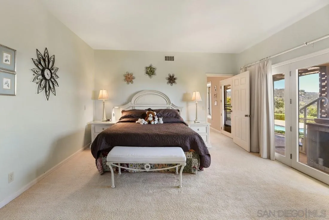 15938 Overview Road Poway, CA 92064 - Photo 35 of 72 a bedroom with a bed and a chair