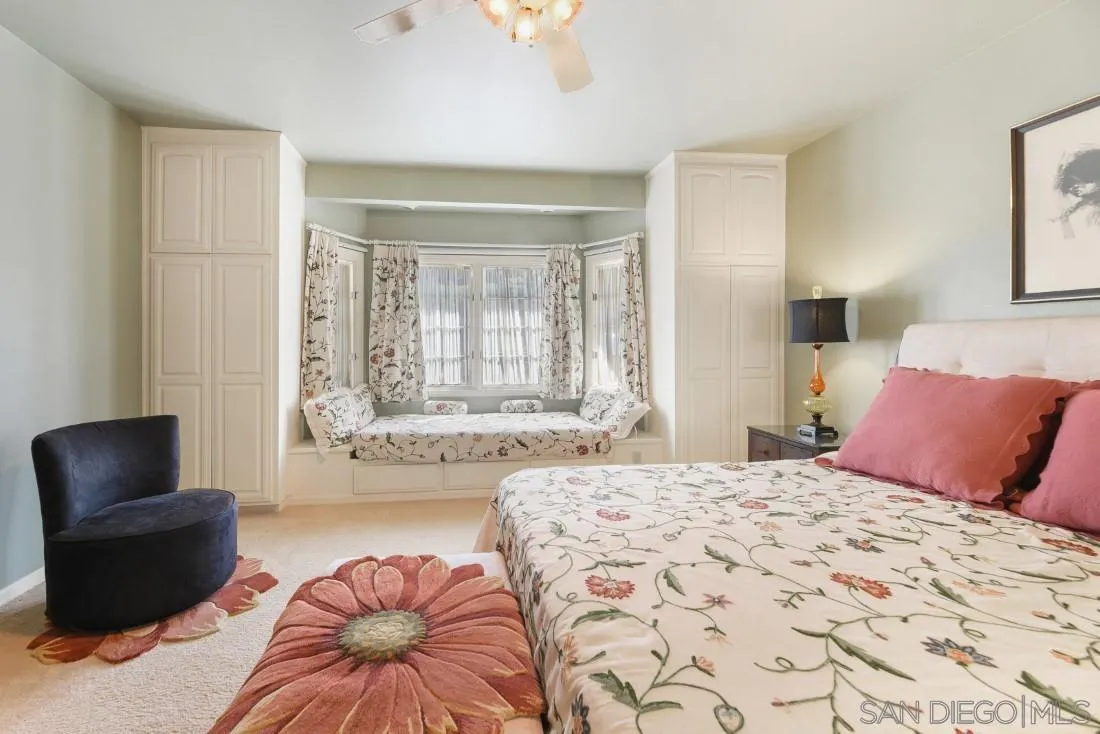 15938 Overview Road Poway, CA 92064 - Photo 38 of 72 a bedroom with a bed and a couch with window