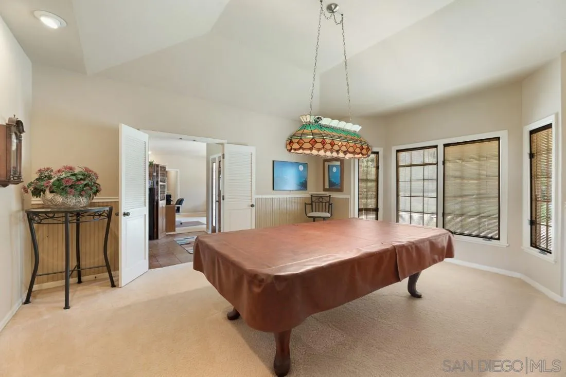 15938 Overview Road Poway, CA 92064 - Photo 44 of 72 a bed room with a bed and a chandelier