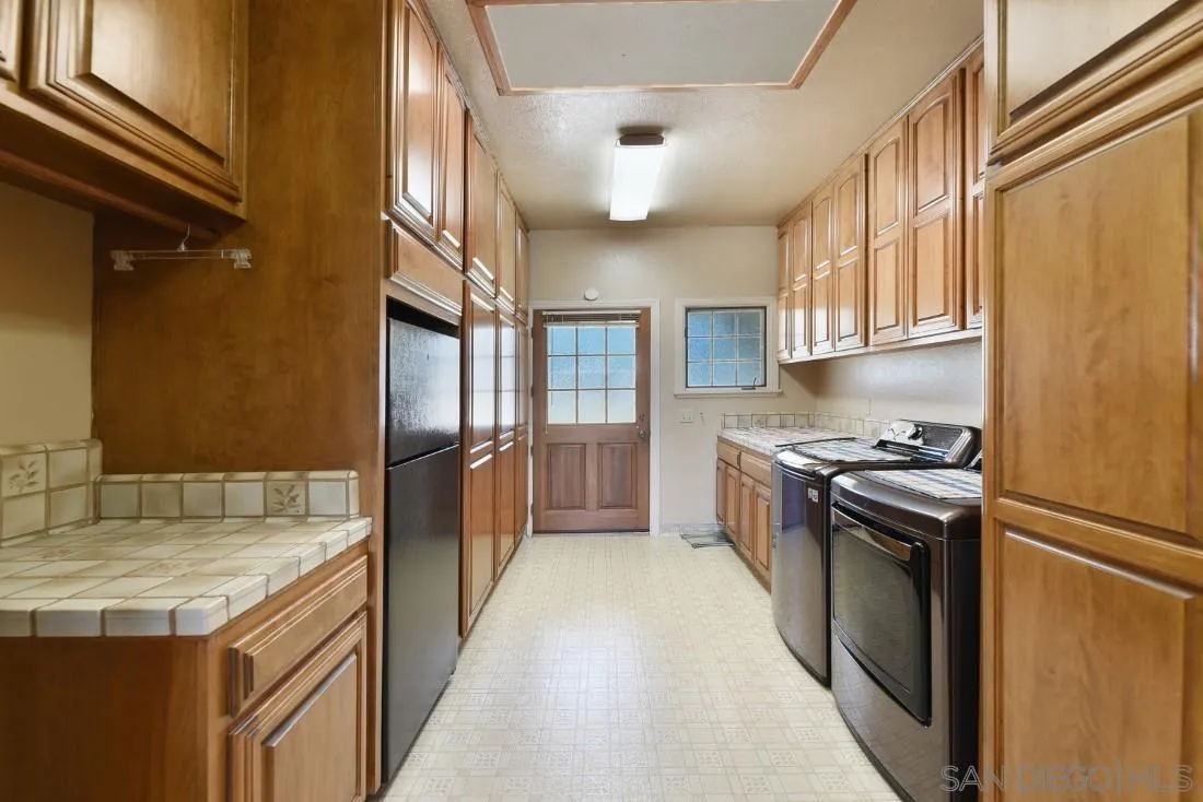 15938 Overview Road Poway, CA 92064 - Photo 55 of 72 a kitchen with granite countertop a sink appliances and cabinets