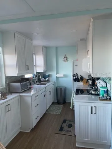 a kitchen with sink cabinets and stove