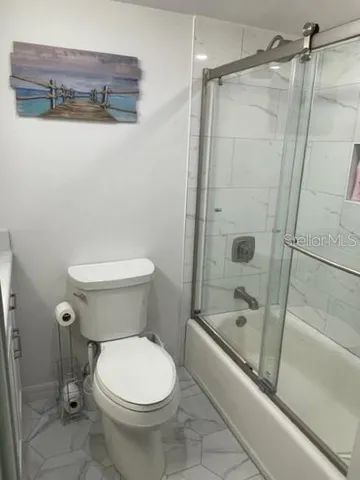 a bathroom with a toilet and a shower