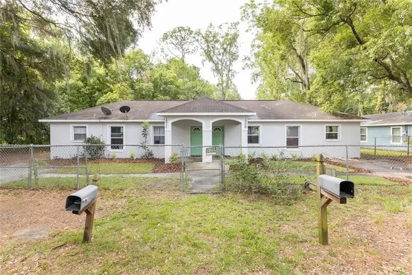 a front view of a house with a yard table and chairs