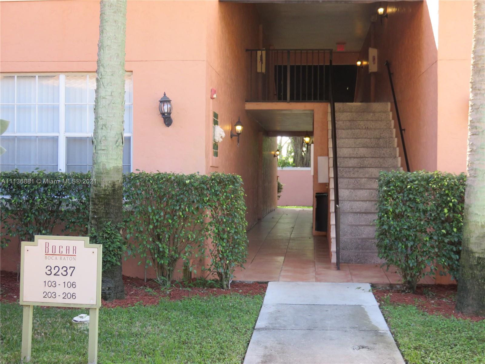3237 Clint Moore Road, Unit 204 Boca Raton, FL 33496 - Photo 1 of 13 a view of a door and an outdoor space