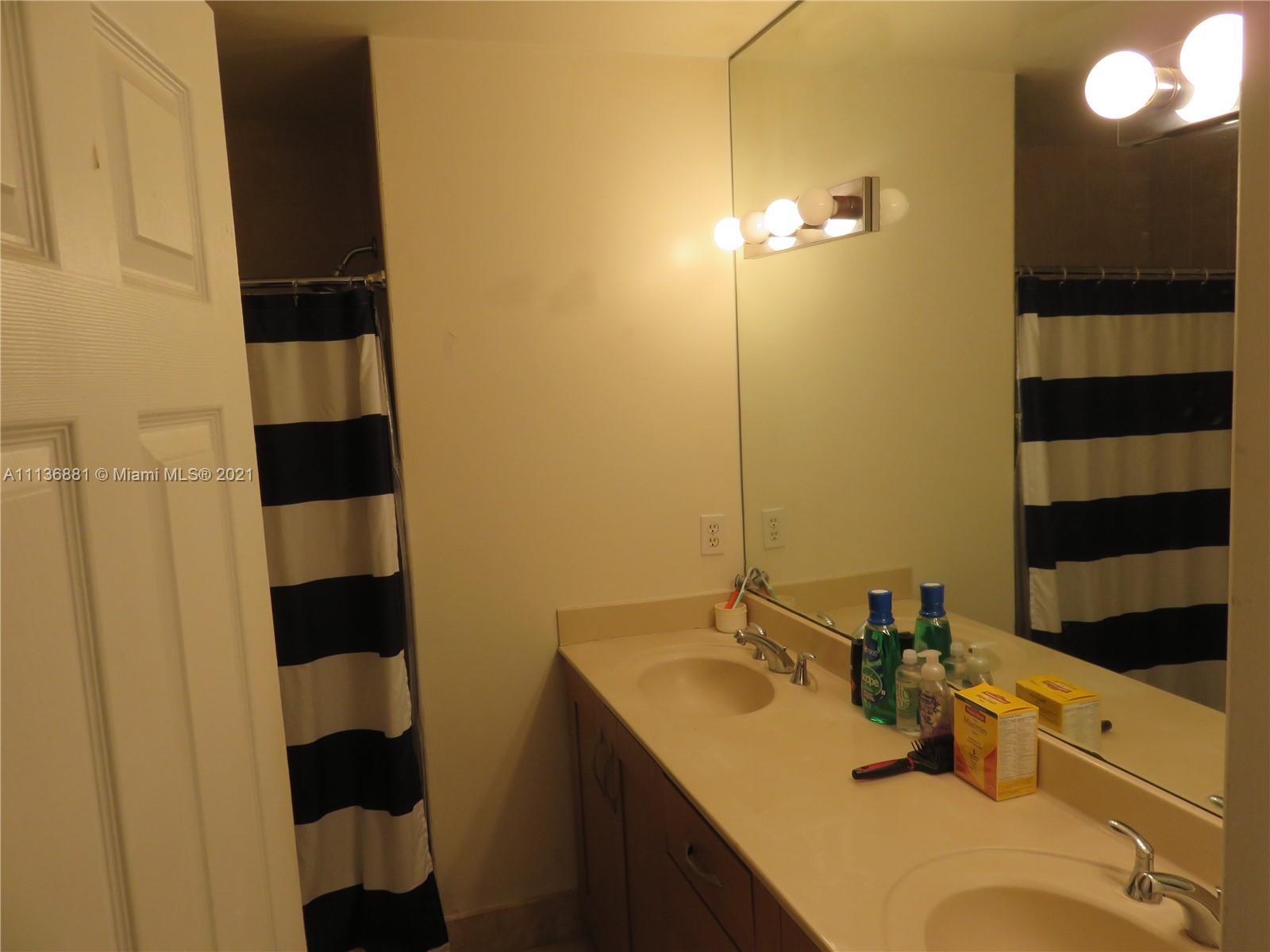 3237 Clint Moore Road, Unit 204 Boca Raton, FL 33496 - Photo 13 of 13 a bathroom with a sink and a mirror