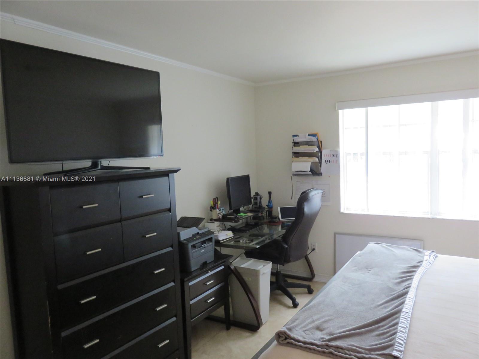 3237 Clint Moore Road, Unit 204 Boca Raton, FL 33496 - Photo 9 of 13 a livingroom with a window and a flat screen tv